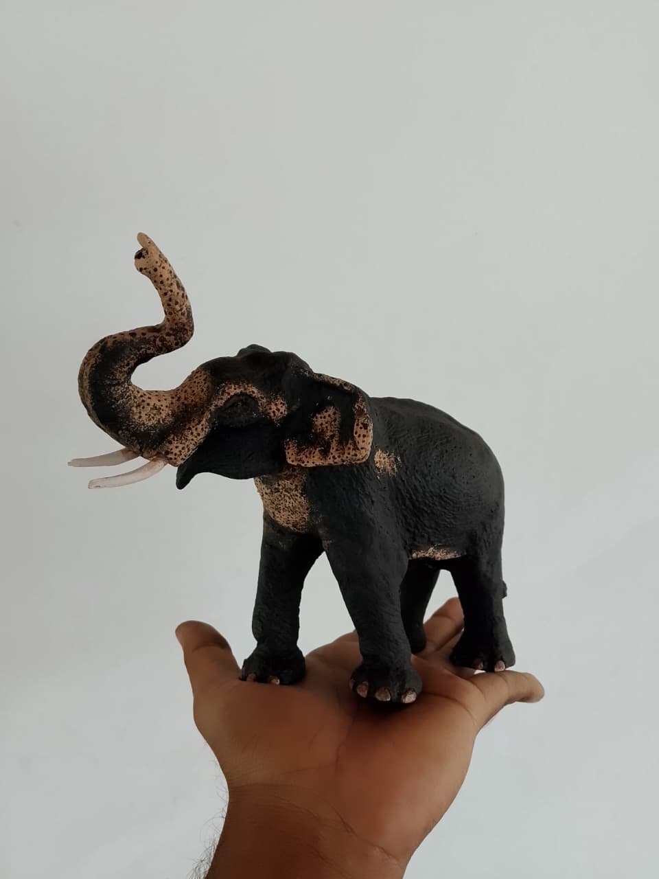 Side view of the Jaya elephant sculpture with its trunk curled upward